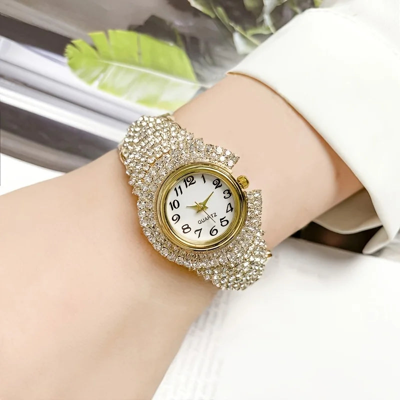 A close-up of an elegant full rhinestone quartz wristwatch worn on a wrist, set against a white background.