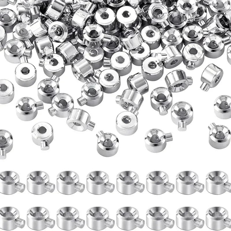 A close-up view of various silver jewelry findings stoppers and spacers for connectors.