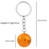 A round, orange glass charm with a small red star attached to a silver keyring.