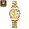 A gold-toned ladies wristwatch with a metal bracelet and luminous features.