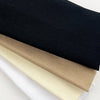 A set of four knitted hair bands in black, beige, and white are shown stacked together.