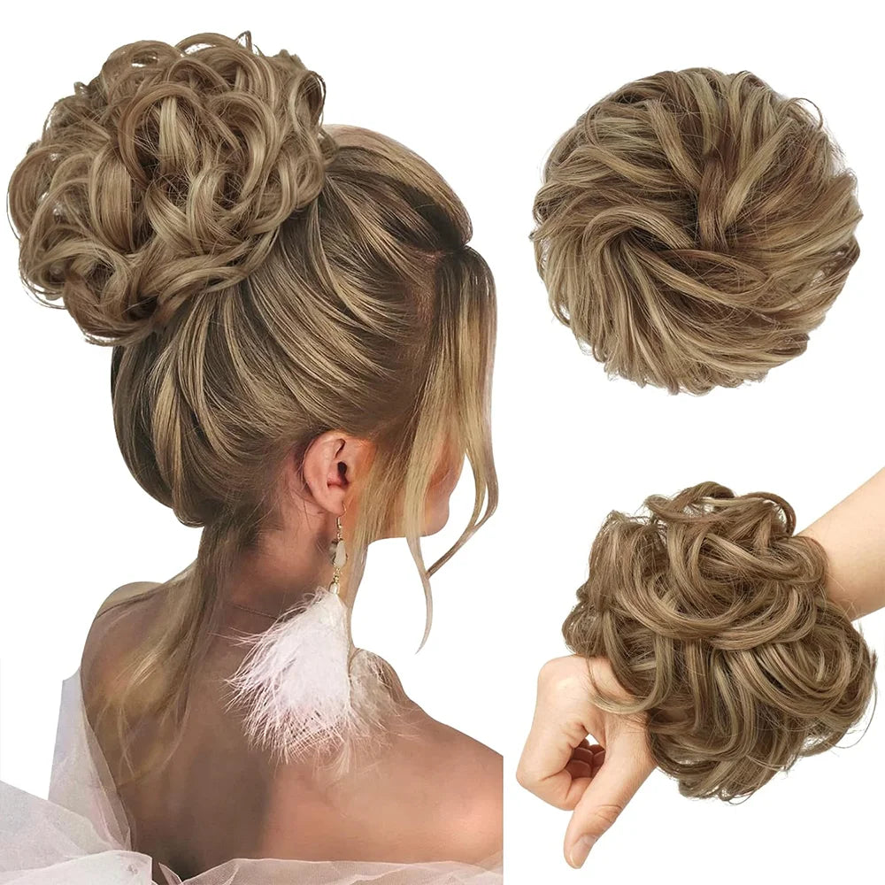 A woman's hair styled in a textured, voluminous updo with a pink feather accent.