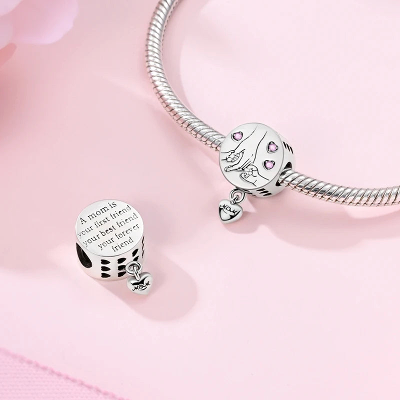 Sterling silver devil's eye charm bracelet featuring a charm with a cat and small hearts