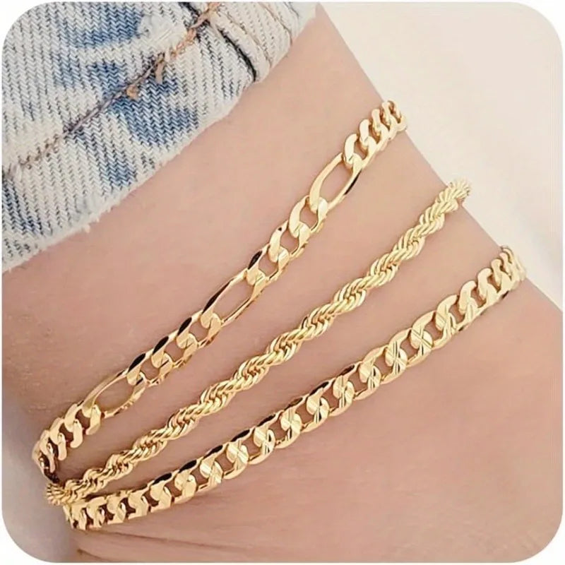 Gold flat snake chain anklets set worn on a wrist for summer fashion
