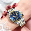 Nahaufnahme einer silbernen Edelstahl-Armbanduhr mit blauem Zifferblatt und goldenen Akzenten am Handgelenk.