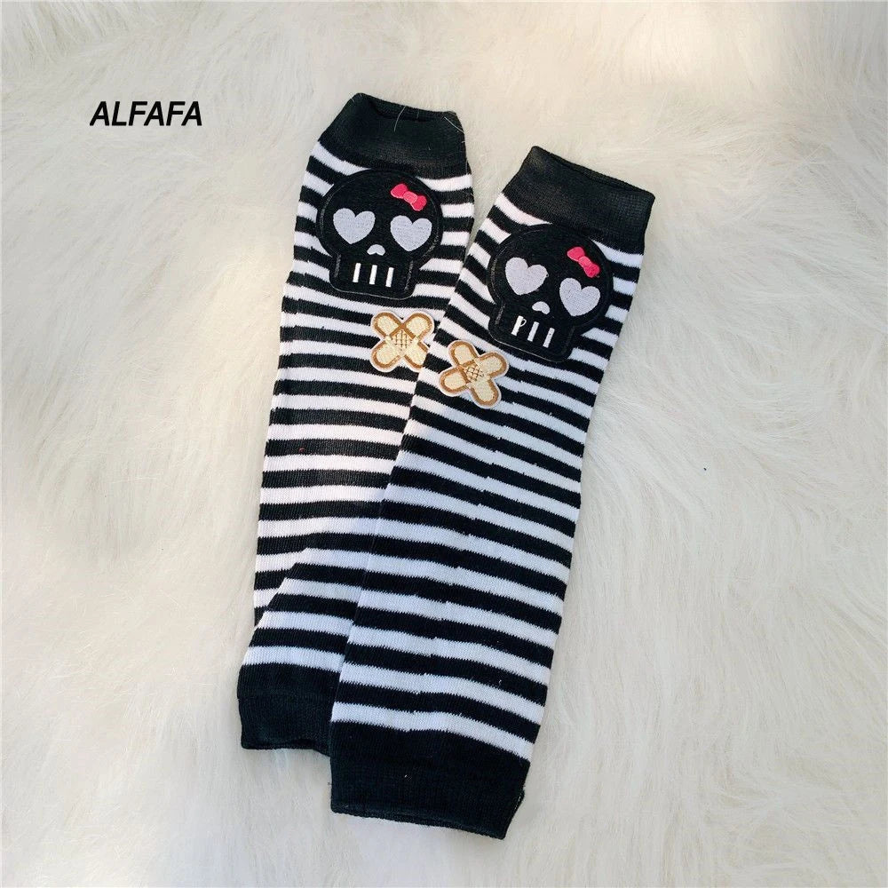 Black and white striped fingerless socks featuring skull and flower designs