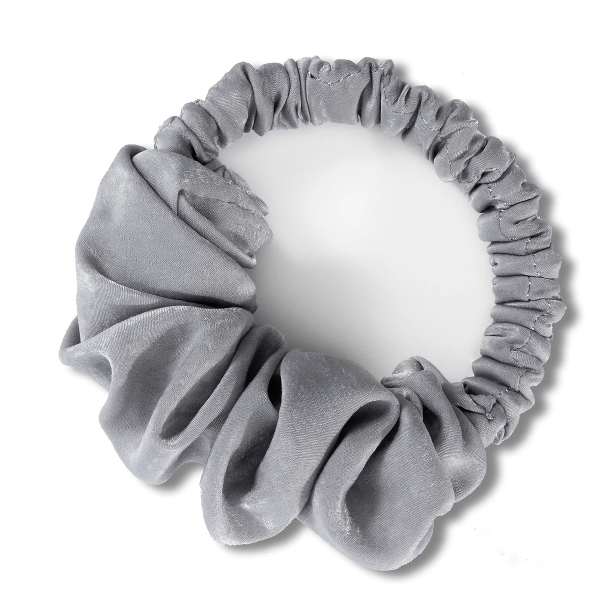 A gray heatless hair curling scrunchie made of gathered fabric.