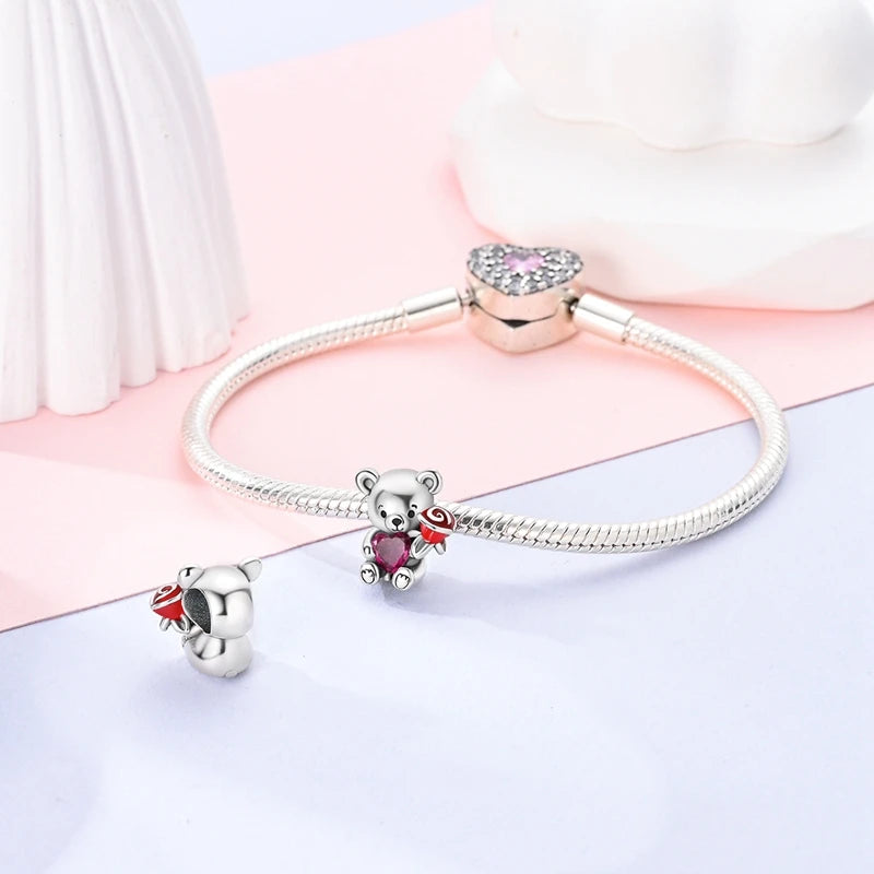 Sterling silver devil's eye charm bracelet with a pink gemstone and a bear charm