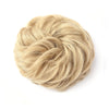 A light blonde, textured hair piece styled into a large messy bun for updos.