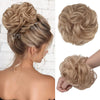 A woman shows off a blonde messy bun hairstyle with decorative hair pieces and scrunchies.