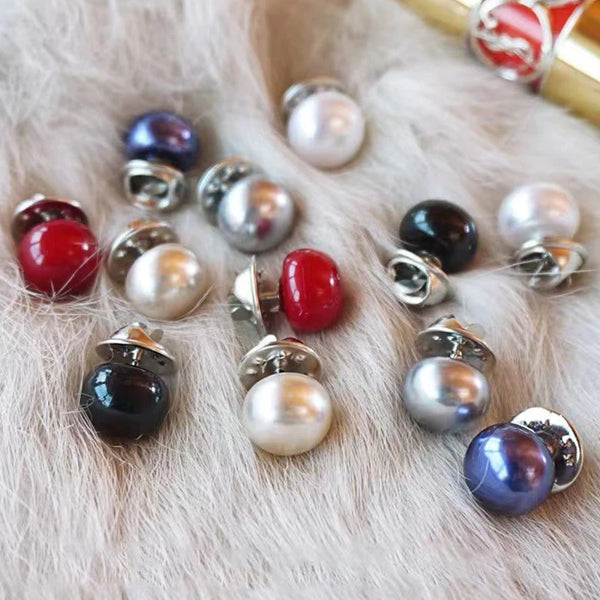 Collection de boutons de perles et de pierres précieuses de différentes couleurs et finitions éparpillés sur de la fourrure b