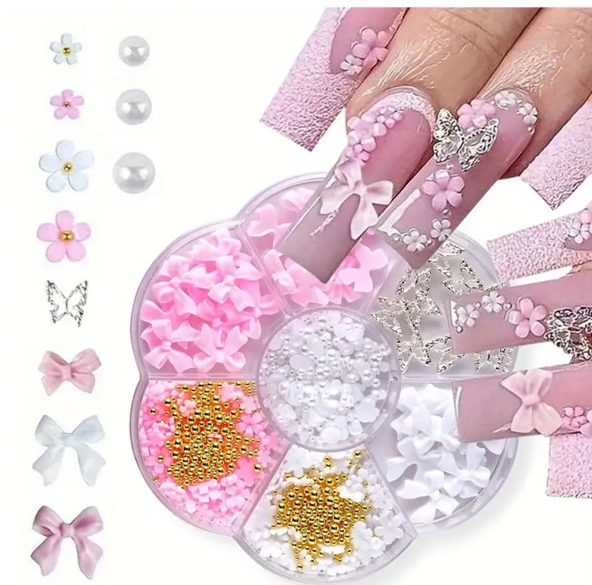 A collection of pink and white butterfly and bow nail charms displayed on a hand.