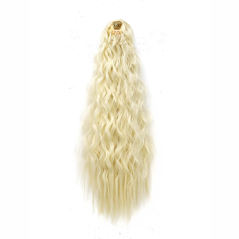 A long, blonde, wavy hair extension with a clip-in top visible against a white background.