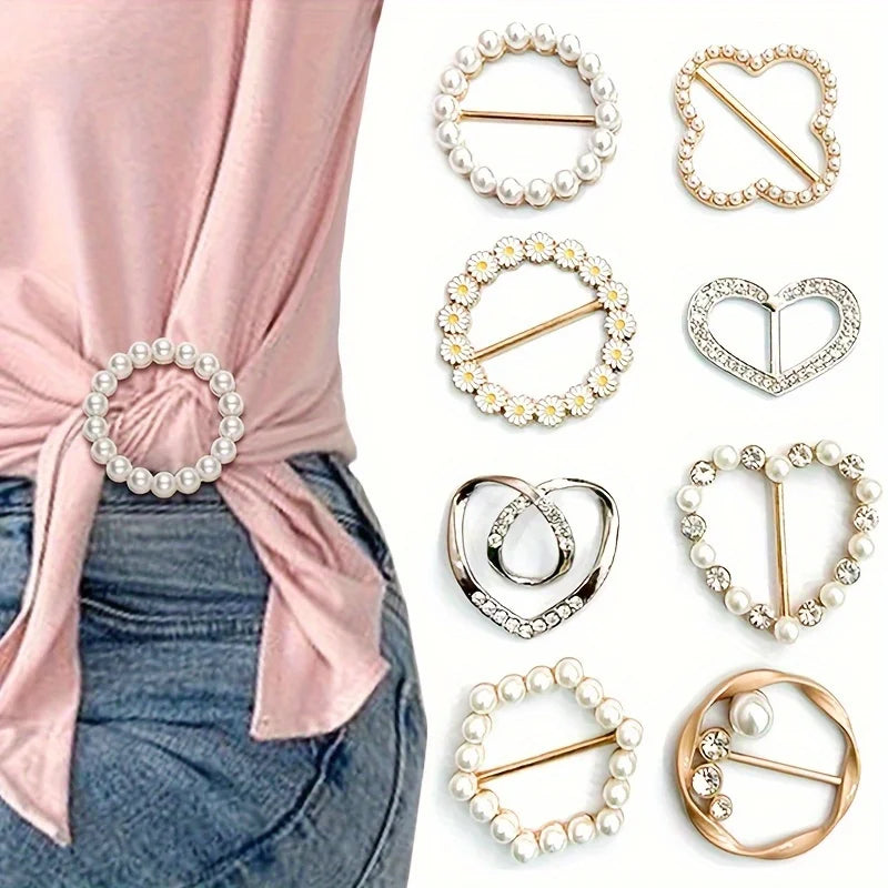 A collection of elegant rhinestone and pearl decorative button clips in various shapes and finishes.
