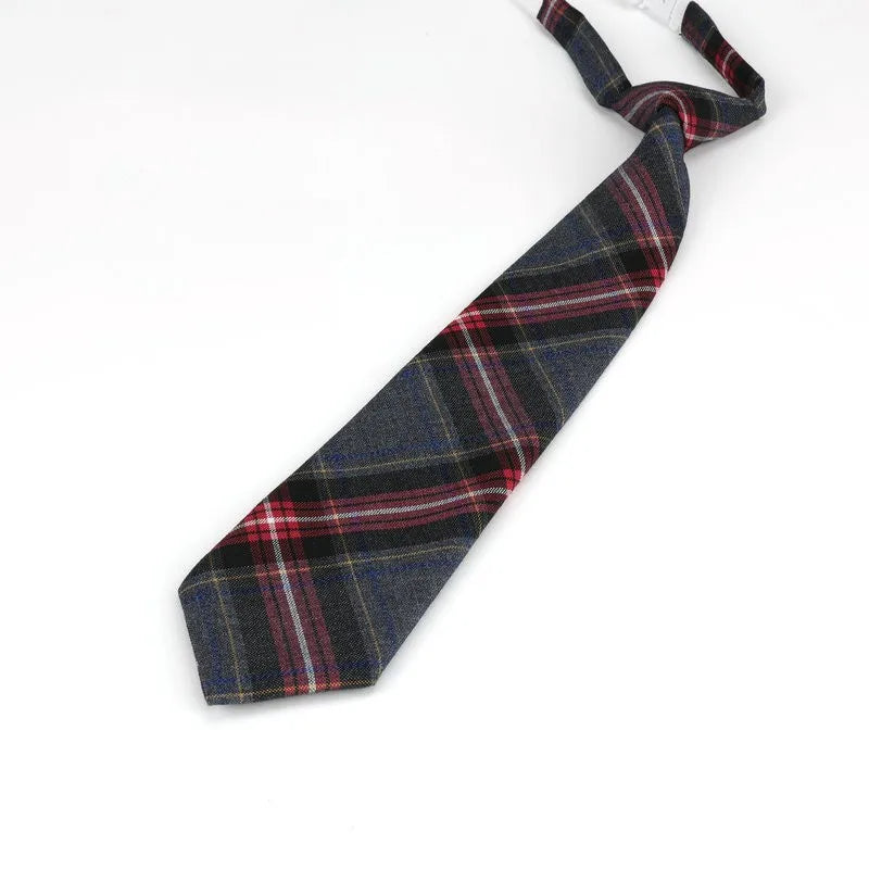 A dark blue and red plaid necktie folded and displayed against a white background.