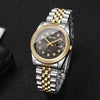 A silver-toned wristwatch with a gold-tone bracelet and a round face featuring a black dial and small diamond accents.