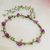 A delicate green floral headband made of small purple roses and leaves for women's hair.