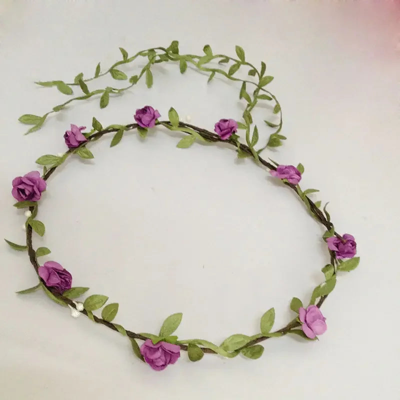 A delicate green floral headband made of small purple roses and leaves for women's hair.