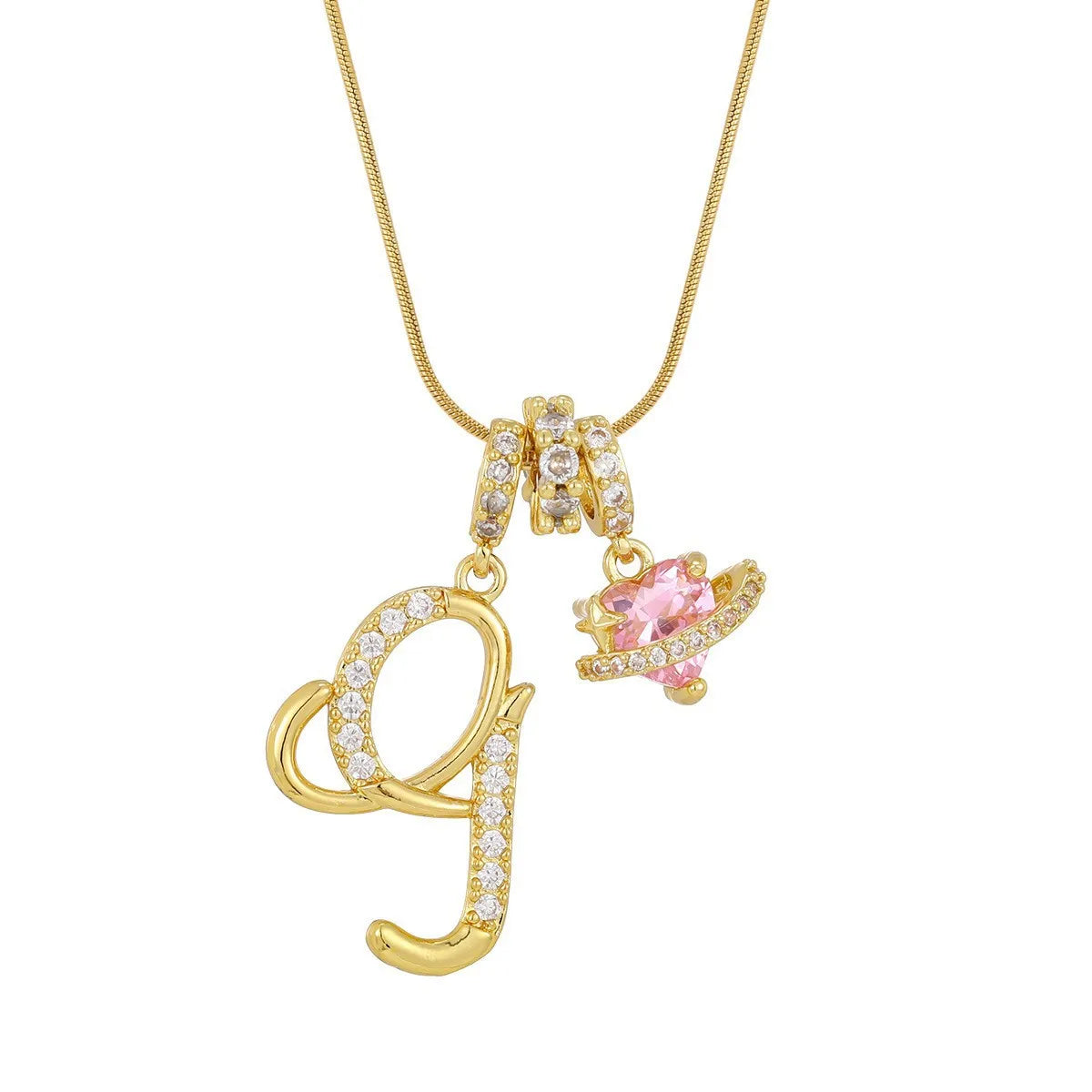 A gold letter pendant necklace featuring the letter G and a pink gemstone charm.