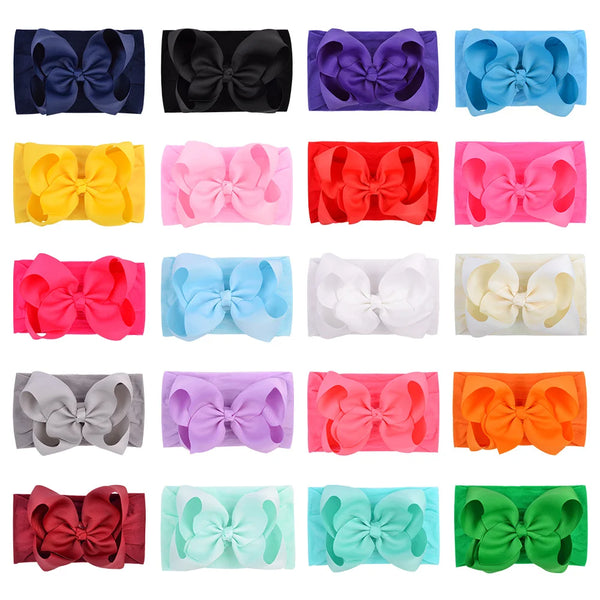 A collection of colorful soft baby headbands featuring various chunky hair bows in shades of purple, pink, blue, yellow, and 