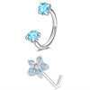 A set of silver horseshoe nose rings featuring round blue topaz stones.