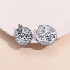 Two circular enamel lapel brooches featuring text and hand imagery on a light background.