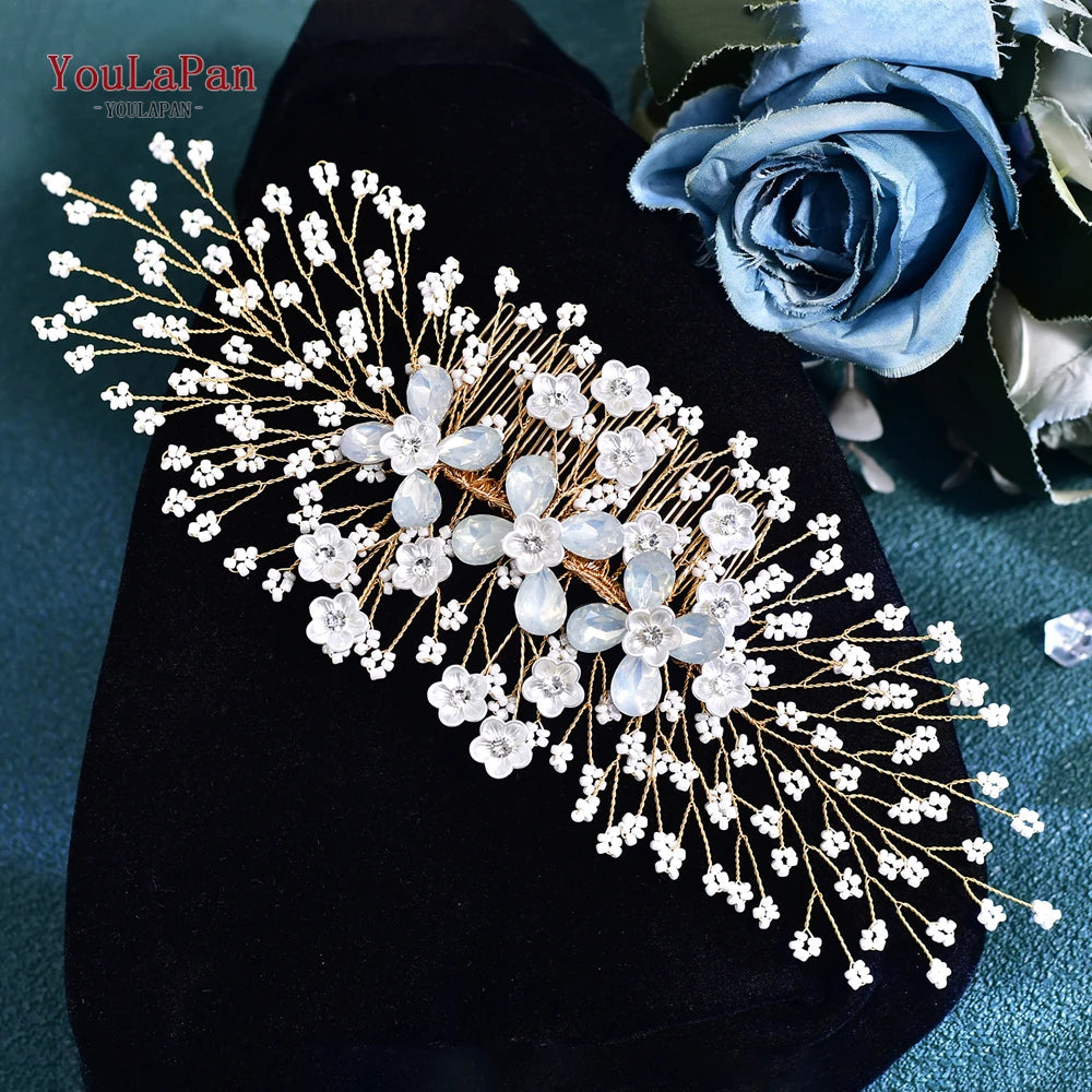 A delicate bridal headband or tiara made of clear rhinestones and small white flowers on a dark velvet background.