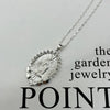 A dainty golden Christian necklace featuring a textured pendant design.