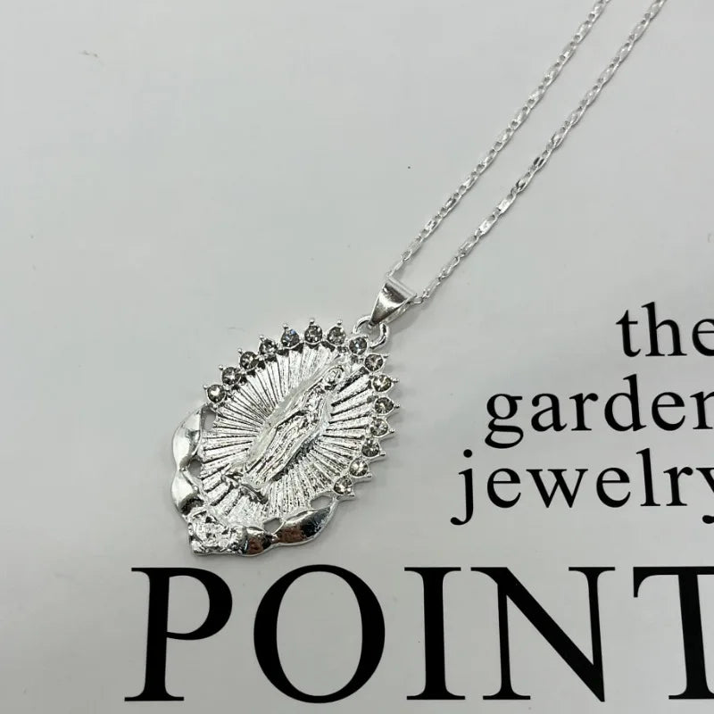 A dainty golden Christian necklace featuring a textured pendant design.