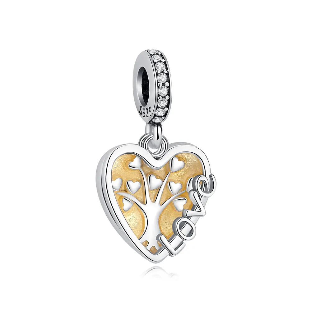 A silver heart pendant charm featuring a detailed family tree design with small leaves.