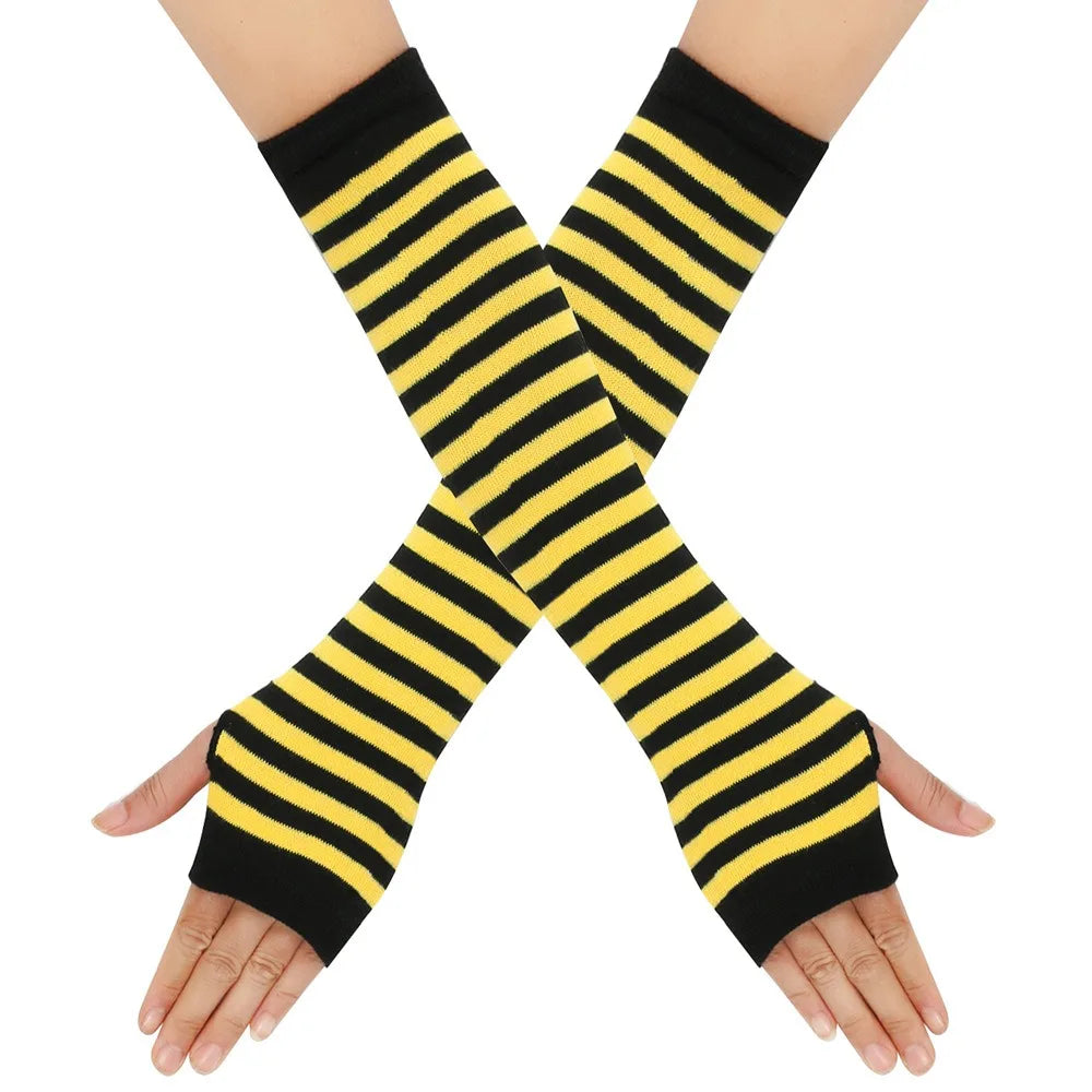Elegant knitted fingerless gloves with black and yellow horizontal stripes crossed on a hand