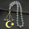 Gold-toned stainless steel pendant necklace featuring a crescent moon and star charm with clear crystal beads.