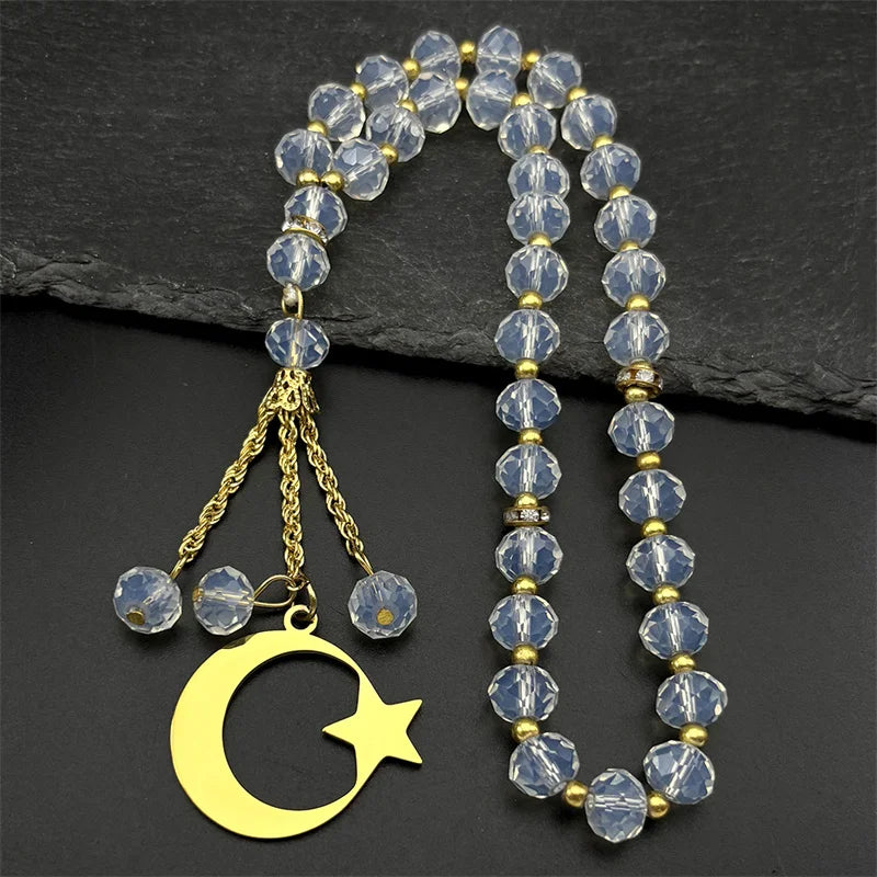 Gold-toned stainless steel pendant necklace featuring a crescent moon and star charm with clear crystal beads.