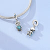 Sterling silver charm bracelet featuring a devil's eye charm and a small dog charm.