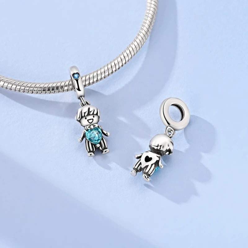 Sterling silver charm bracelet featuring a devil's eye charm and a small dog charm.