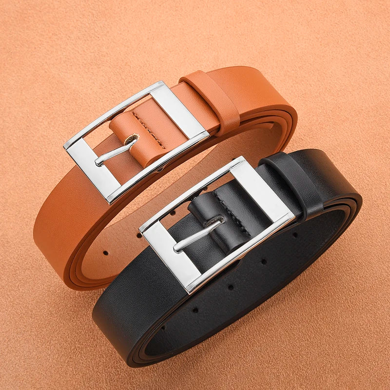 A brown leather belt with a silver metal pin buckle is shown on a beige background.