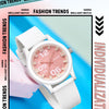 A white classic quartz fashion watch with a rose gold dial and silicone strap displayed on a blue background.