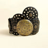 A stack of vintage black PU disc belts with gold metal buckles.
