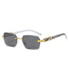 Frameless gradient sunglasses with gray lenses and gold accents on a white frame