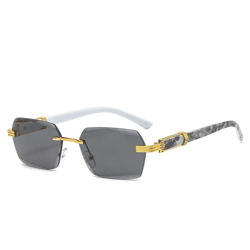 Frameless gradient sunglasses with gray lenses and gold accents on a white frame