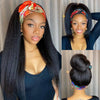 A woman models a straight synthetic headband wig with long black hair and makeup.