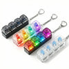 A set of clickable LED fidget keychains featuring various colored lights and a keyboard layout.