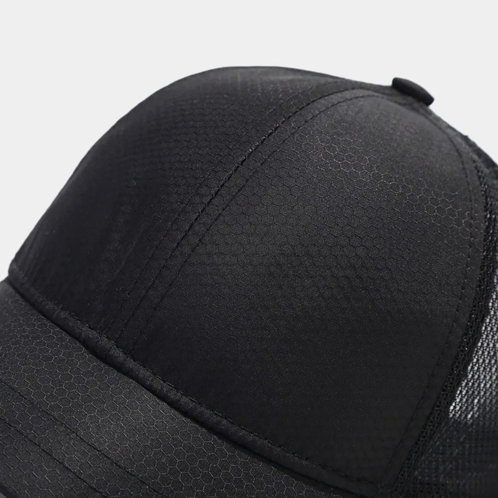 Close-up view of a black mesh sun visor cap.