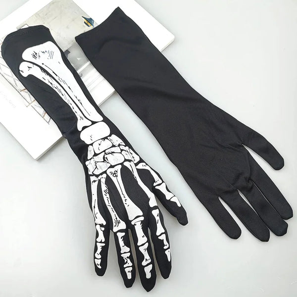 Black gloves with a white skeleton print on the palm and fingers, displayed next to a white box.