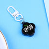 A black LED digital keychain watch with a paw print design attached to a silver keyring.