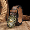 A vintage western PU leather belt with a detailed gold-toned buckle resting on a wooden surface.