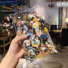 A hand holds a clear plastic bag filled with 10 pieces of cute animal and plant metal pin badges.