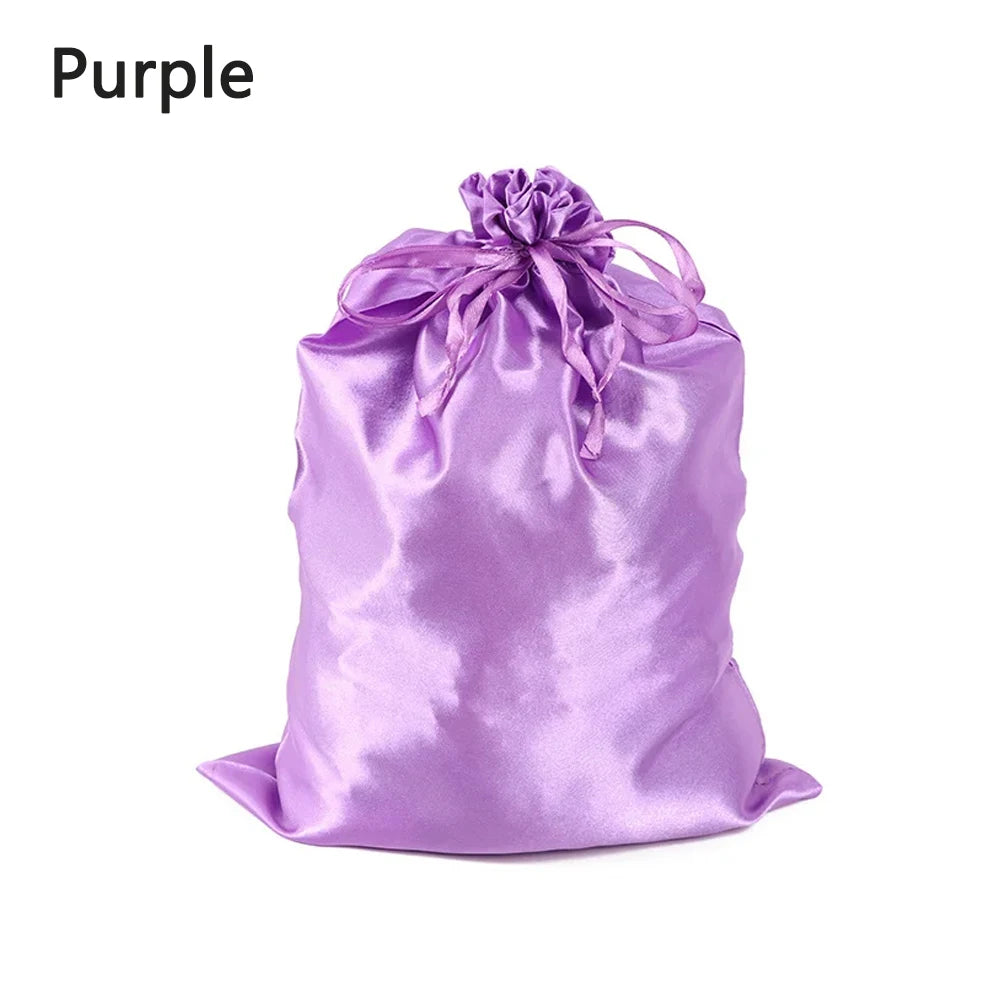 A purple satin drawstring storage bag tied with a bow.