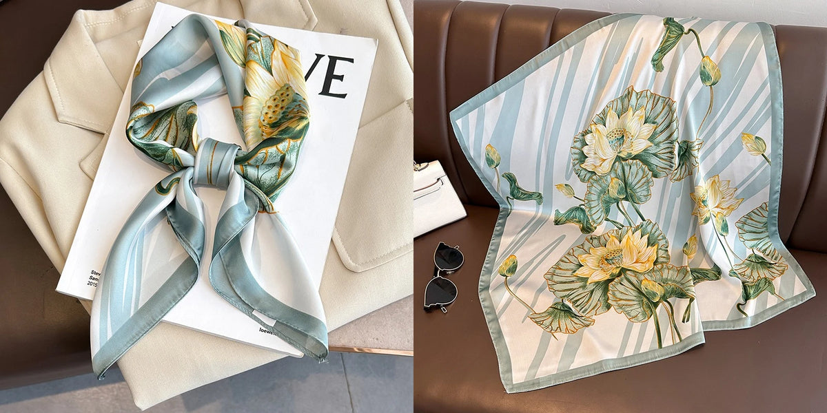 A light blue and yellow floral print silk scarf draped on a beige blazer and a brown leather sofa.