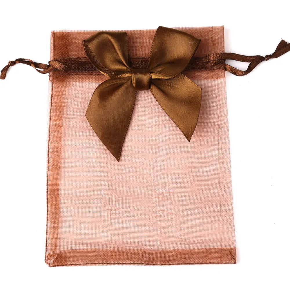A square, sheer peach organza gift bag tied with a satin brown ribbon bow.